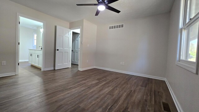 273 Hidden Hills Rd, Lancaster, KY 40444 - unfurnished bedroom with dark wood-style floors, baseboards, multiple windows, and visible vents