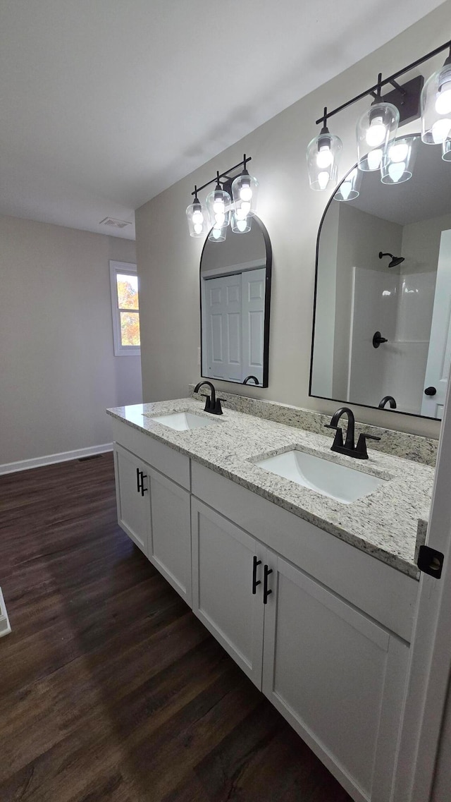 bathroom featuring vanity, hardwood / wood-style floors, and a shower