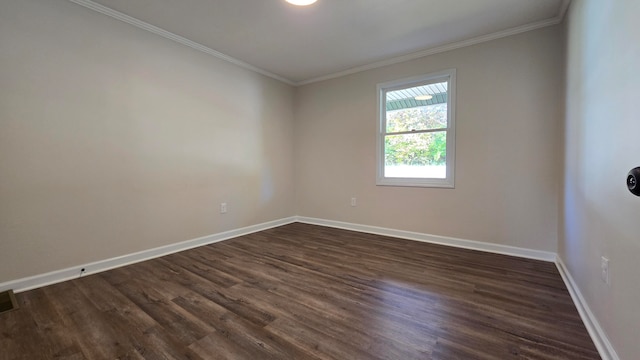 unfurnished room featuring dark wood-type flooring and crown molding