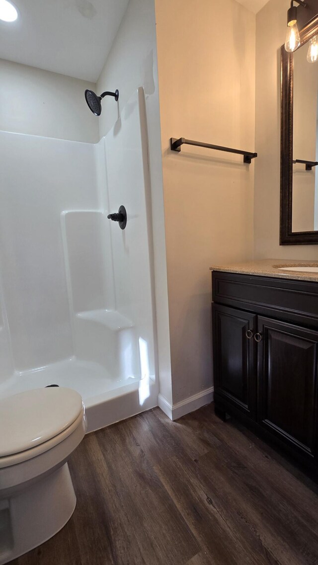 273 Hidden Hills Rd, Lancaster, KY 40444 - full bath with wood finished floors, toilet, vanity, baseboards, and walk in shower