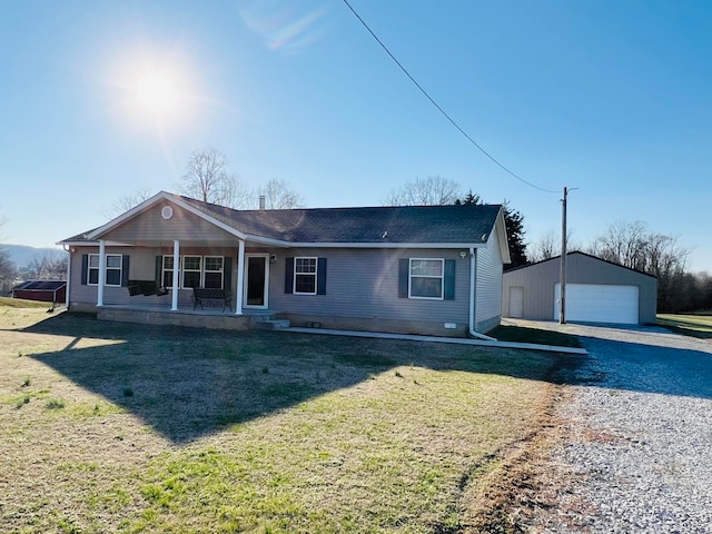 view of front of property with an outdoor structure, a front yard, and a garage