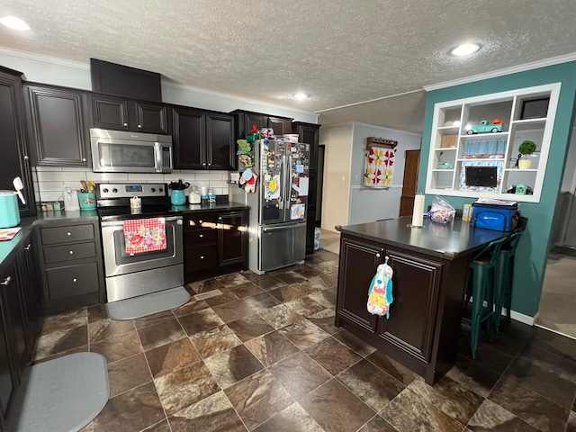 kitchen with ornamental molding, a textured ceiling, stainless steel appliances, and backsplash