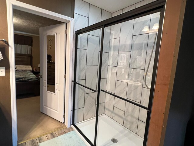 bathroom featuring hardwood / wood-style flooring and a shower with shower door