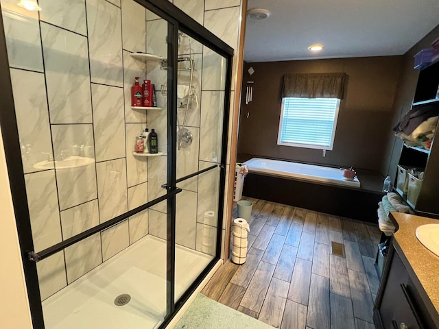 bathroom featuring vanity, hardwood / wood-style floors, and independent shower and bath