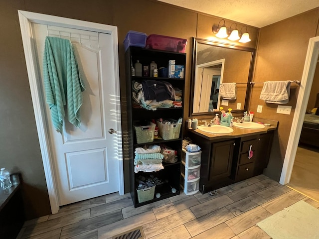 bathroom with vanity and a textured ceiling