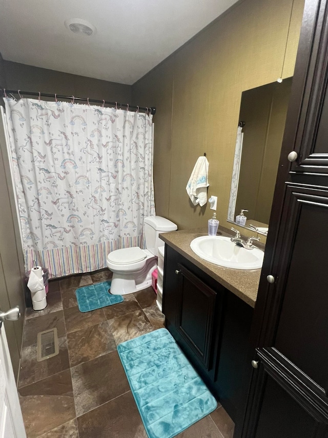 bathroom featuring toilet, a shower with curtain, and vanity