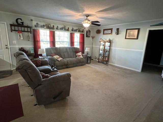 living room with crown molding, light colored carpet, and ceiling fan