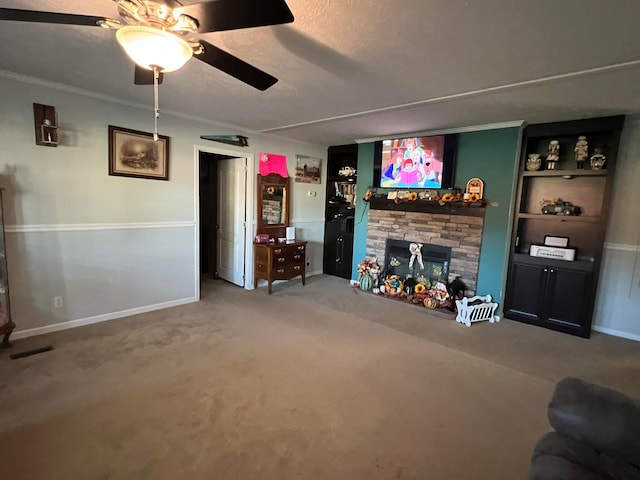 carpeted living room featuring ceiling fan and a fireplace