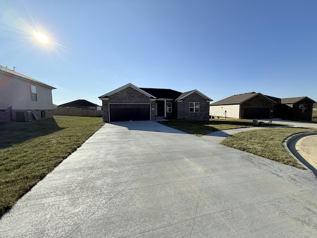 view of front facade with central AC unit, a garage, and a front lawn