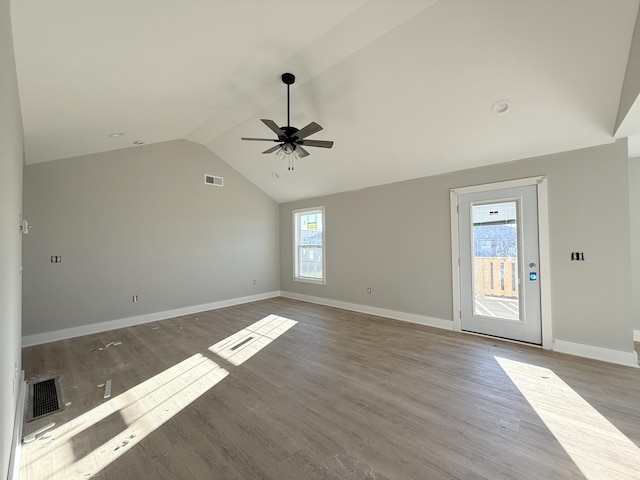 interior space with lofted ceiling, a healthy amount of sunlight, and light wood-type flooring