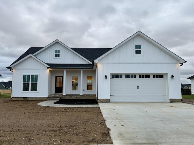 modern farmhouse style home featuring a porch and a garage