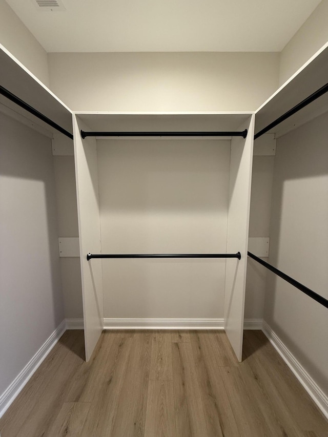 walk in closet featuring hardwood / wood-style flooring