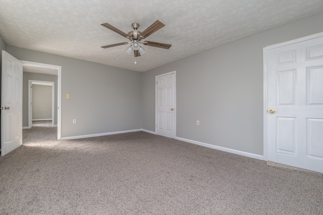 unfurnished bedroom featuring carpet flooring, a textured ceiling, and ceiling fan