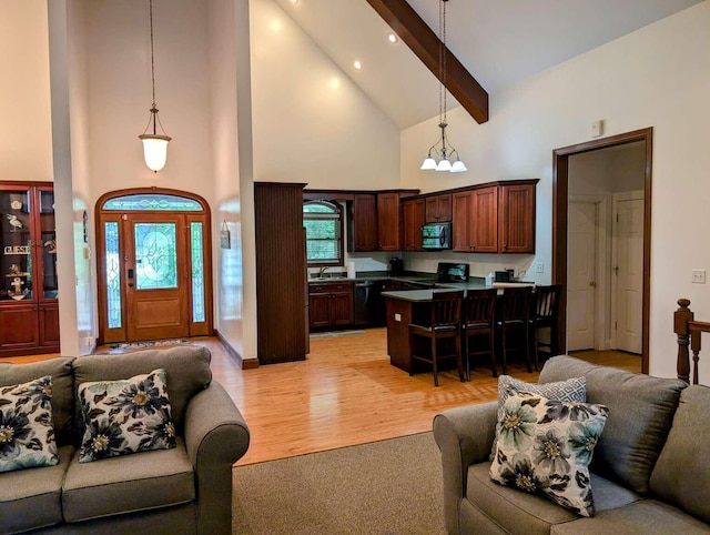 living room with an inviting chandelier, high vaulted ceiling, beamed ceiling, light hardwood / wood-style floors, and sink