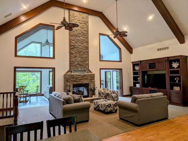 living room with beamed ceiling, hardwood / wood-style floors, a fireplace, high vaulted ceiling, and ceiling fan