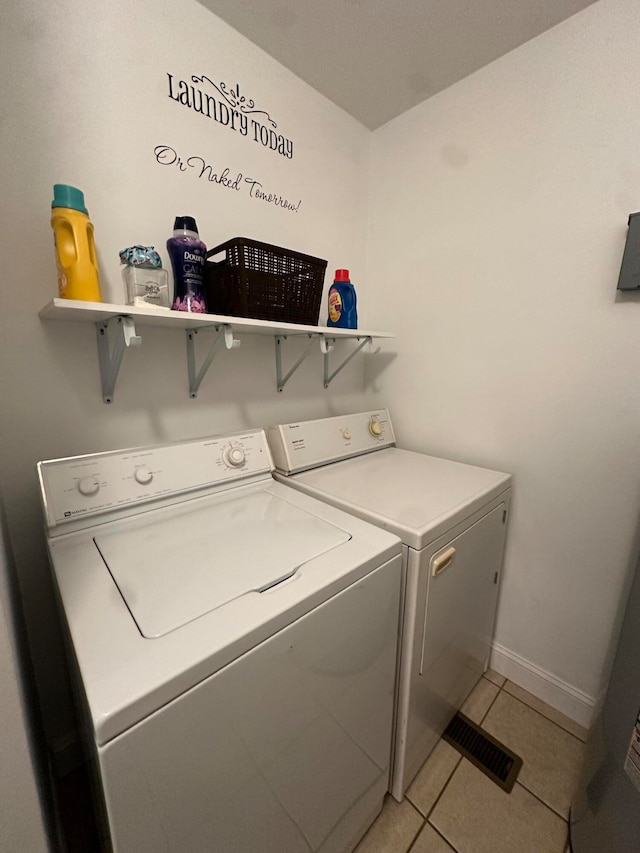 laundry area featuring separate washer and dryer and light tile patterned floors