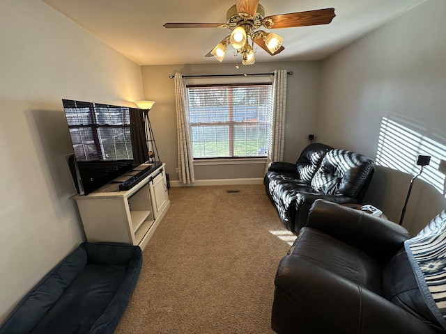 carpeted living room featuring ceiling fan