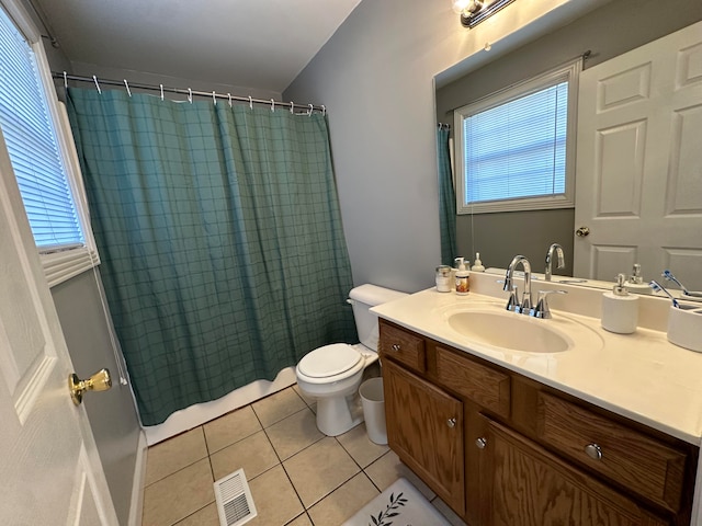 bathroom featuring vanity, walk in shower, toilet, and tile patterned flooring