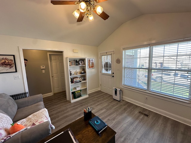 living room featuring hardwood / wood-style flooring, vaulted ceiling, and ceiling fan