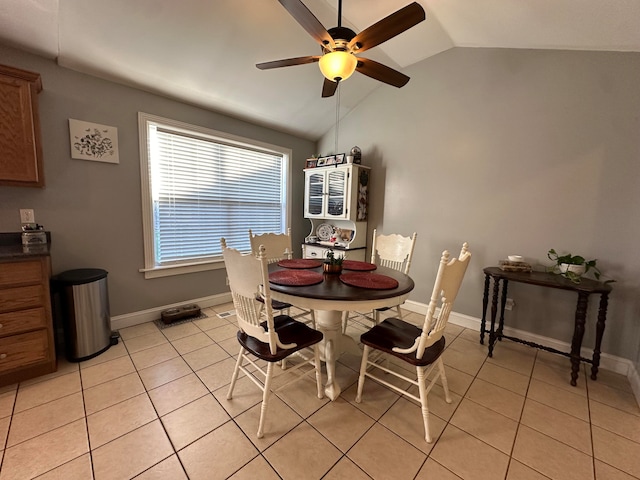 tiled dining room featuring ceiling fan and lofted ceiling