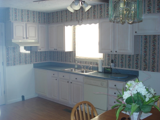 kitchen with sink, white cabinetry, dishwasher, and dark wood-type flooring