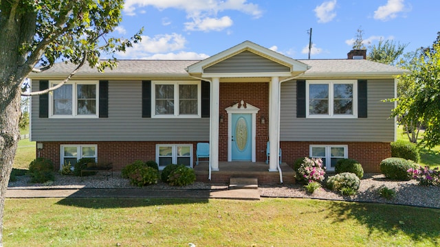 raised ranch featuring a front lawn