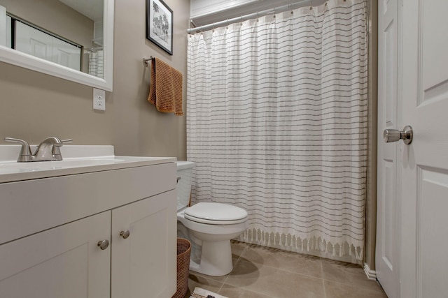 bathroom with vanity, a shower with curtain, toilet, and tile patterned floors