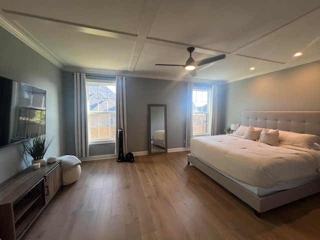 bedroom featuring light hardwood / wood-style floors, multiple windows, coffered ceiling, and ceiling fan