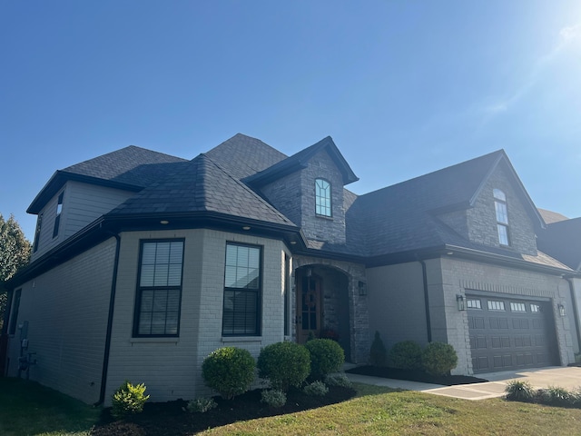 view of front of house with a front yard and a garage