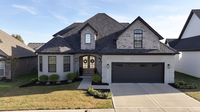 french provincial home featuring a front yard, french doors, and a garage