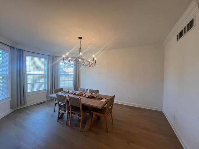 dining area with dark hardwood / wood-style flooring, a chandelier, and ornamental molding