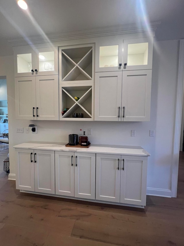 bar featuring white cabinetry and dark wood-type flooring