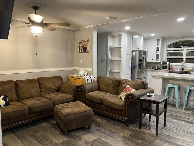 living room with ceiling fan, dark hardwood / wood-style flooring, built in features, and sink