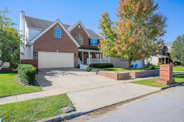 view of front of property with covered porch, a garage, and a front lawn