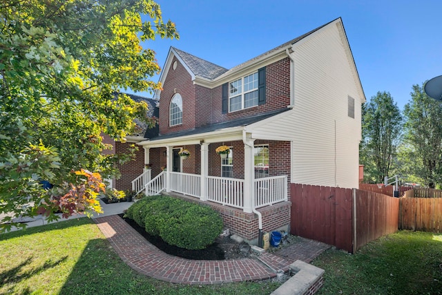 view of front facade featuring a porch and a front lawn