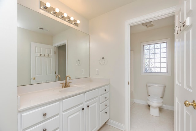 bathroom featuring vanity, toilet, and tile patterned floors