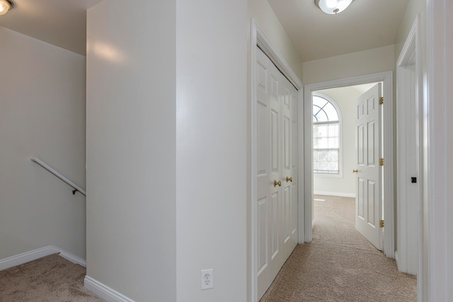 corridor featuring light colored carpet