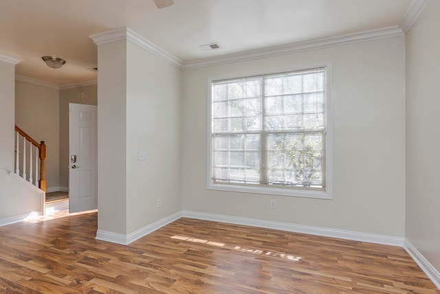 unfurnished room featuring ornamental molding and hardwood / wood-style floors