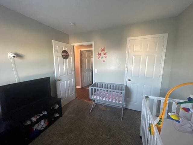 carpeted bedroom with a nursery area