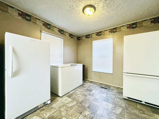 washroom with a textured ceiling