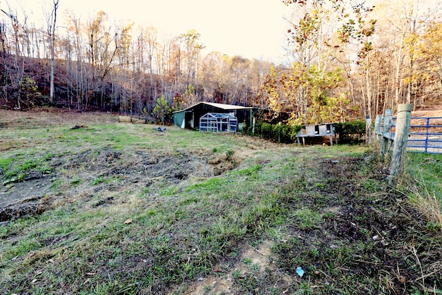 view of yard with a rural view and an outbuilding