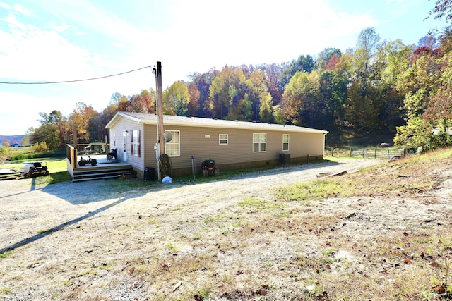 view of home's exterior with a wooden deck