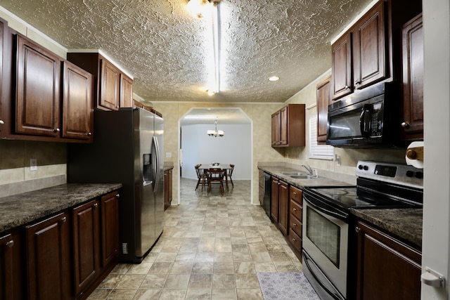 kitchen with sink, black appliances, decorative light fixtures, a notable chandelier, and dark stone countertops