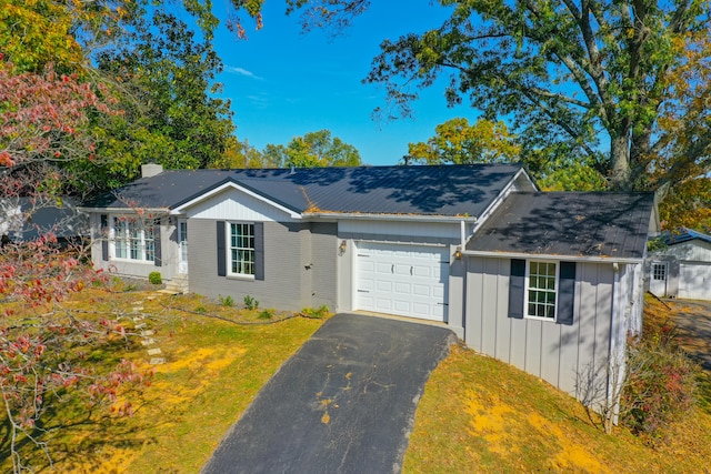 ranch-style home featuring a front lawn and a garage