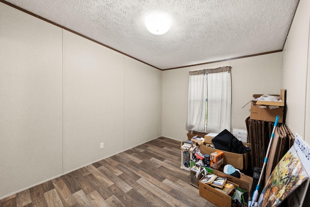 miscellaneous room with crown molding, a textured ceiling, and wood-type flooring