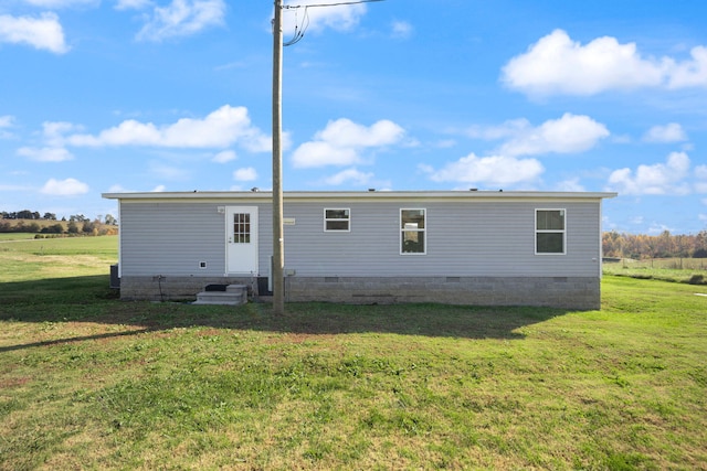 rear view of property featuring a yard