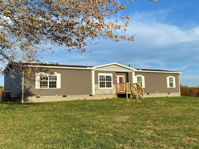 rear view of house with a lawn