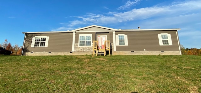 rear view of property with a yard