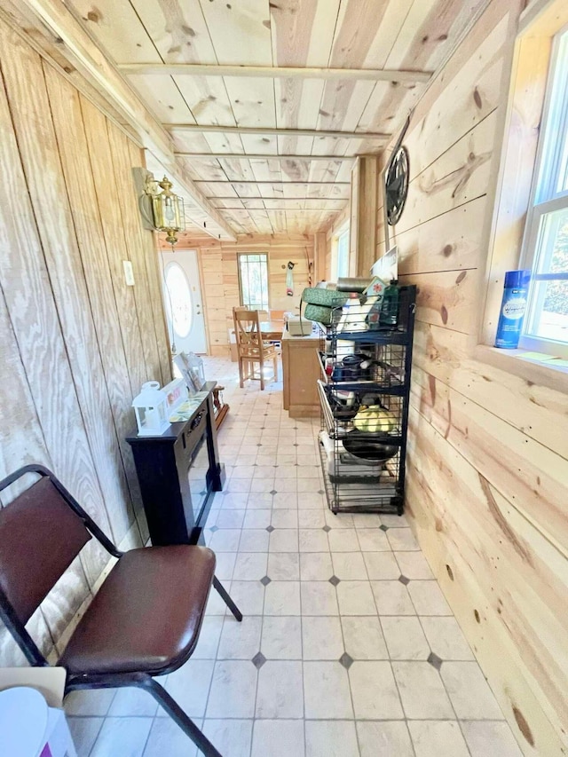 interior space featuring wood walls, wooden ceiling, and light tile patterned floors