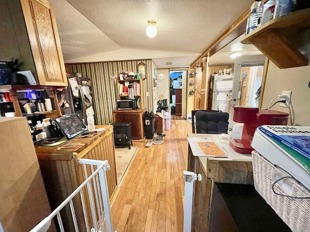 dining area featuring light hardwood / wood-style flooring and lofted ceiling